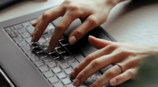 Hands typing on a keyboard